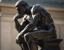 pngtree-statue-of-a-man-sitting-and-thinking-image_2957855.webp